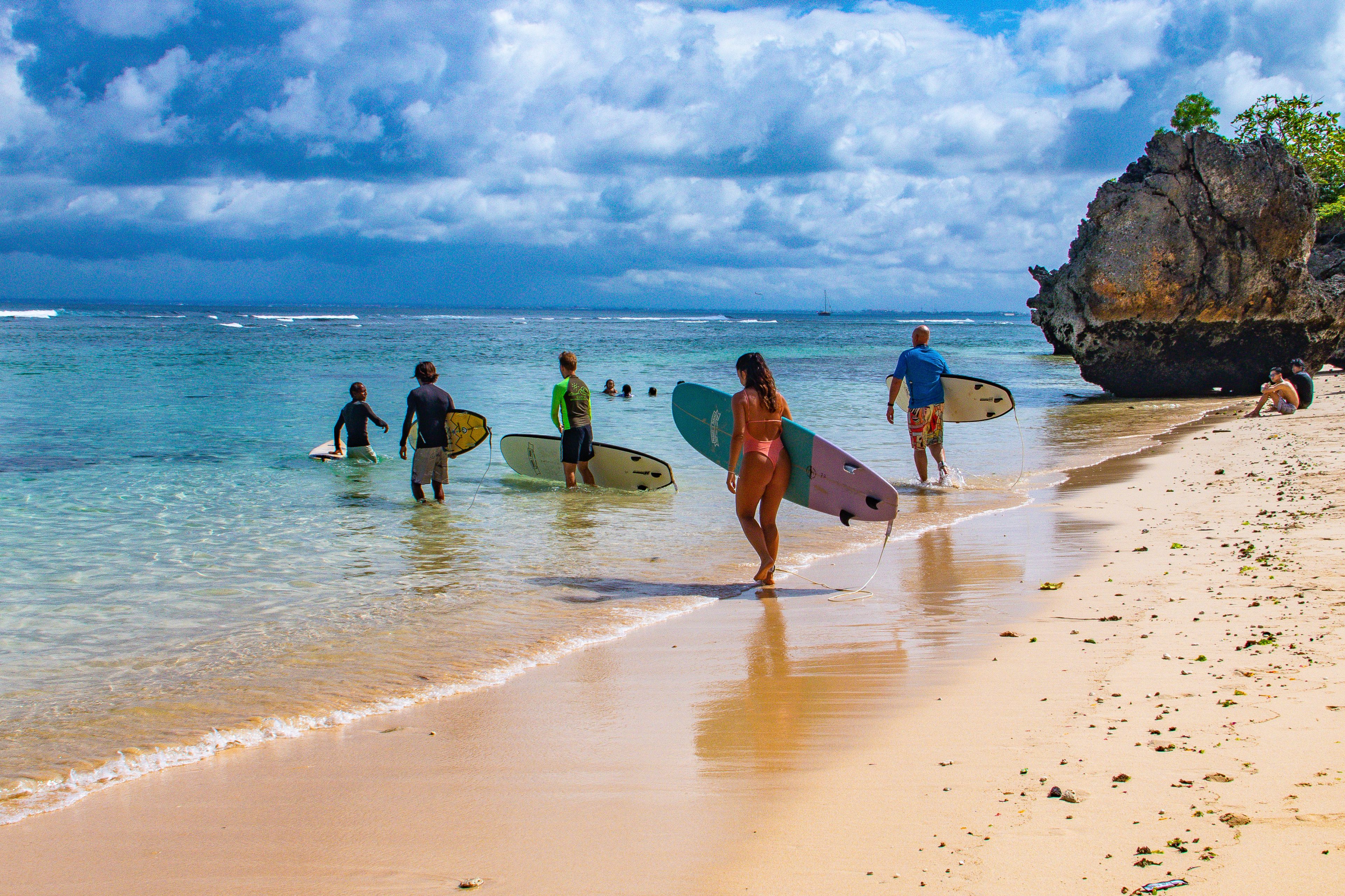 Surfers heading out