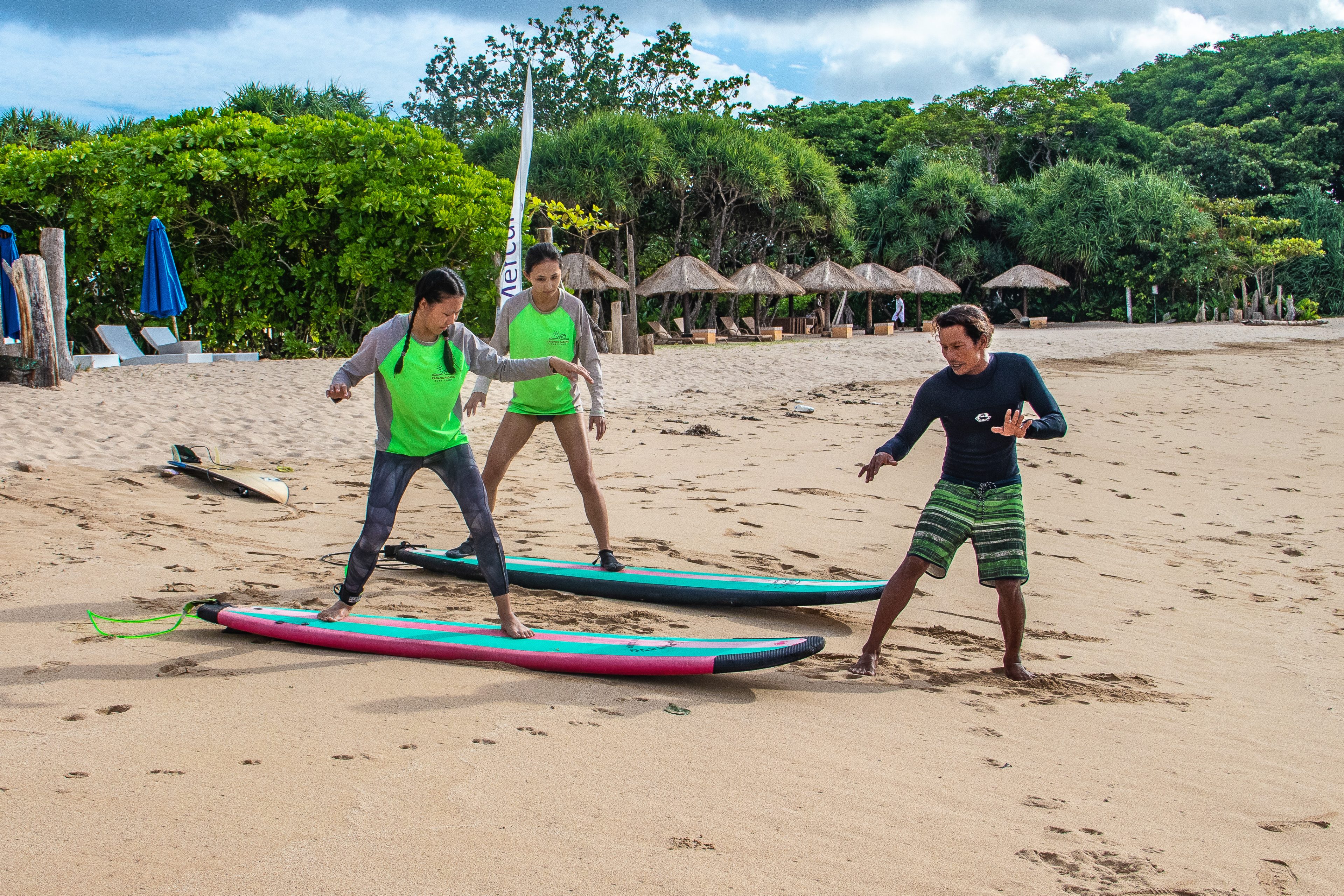 Surf instructor explaining to students.