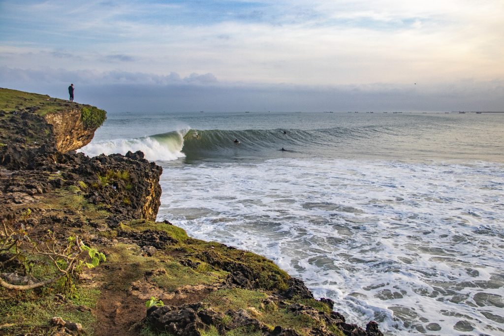 View of surfers from the clifftop at Honeymoons