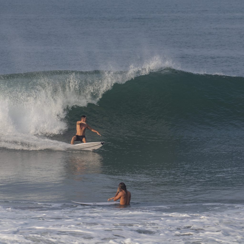 A surfer doing a good bottom turn at the Sandbar.