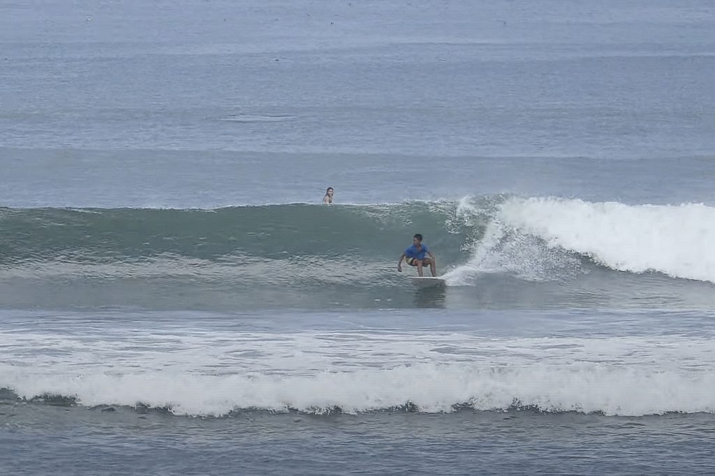 Surfer at Pig Stone beach