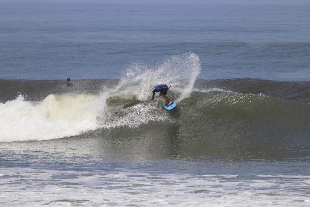 Surfer doing at turn at Balian