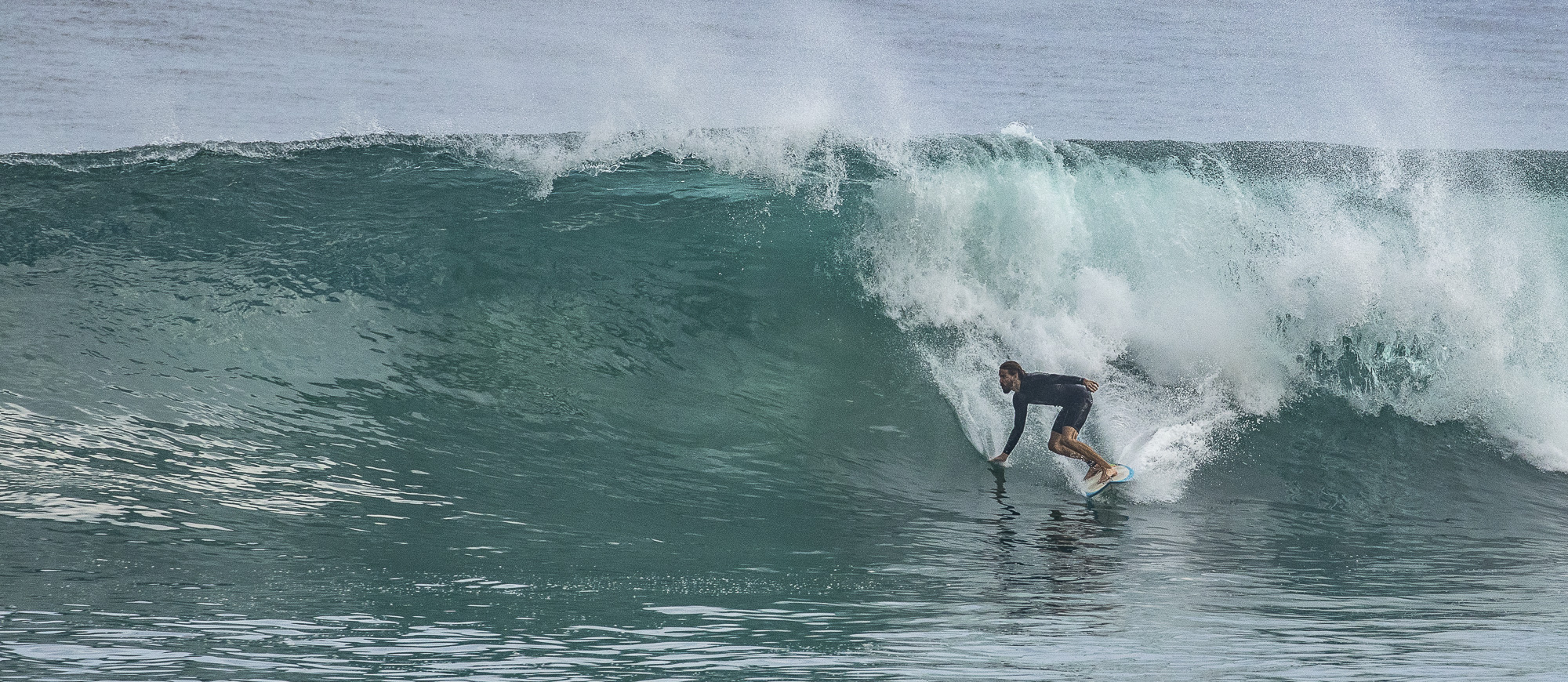 Surfer performing a bottom turn